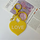 Solid color heart-shaped pendant keychain in purple with silver keyring