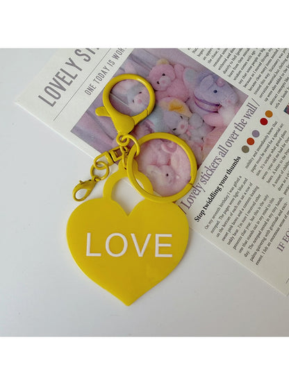 Solid color heart-shaped pendant keychain in purple with silver keyring