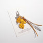 Keypus keychain in leaf shape hanging from a backpack zipper