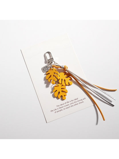 Keypus keychain in leaf shape hanging from a backpack zipper