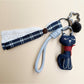 Top view of the fabric cat keychain with visible keyring and fabric texture