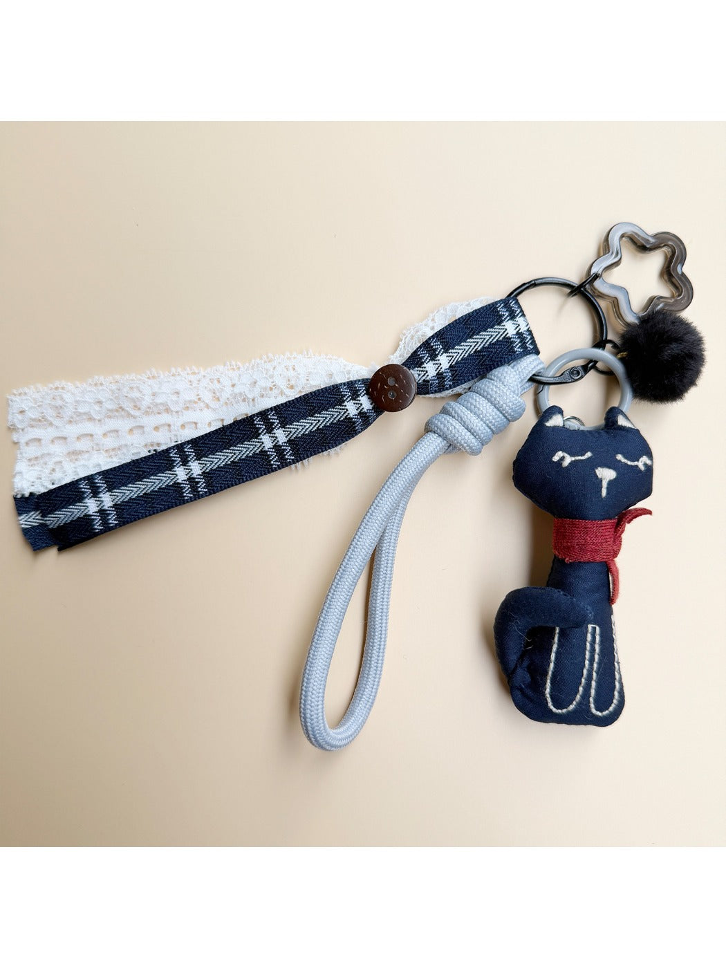 Top view of the fabric cat keychain with visible keyring and fabric texture