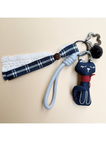 Top view of the fabric cat keychain with visible keyring and fabric texture