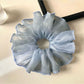 Scrunchies arranged in a circle highlighting their soft fabric and prints