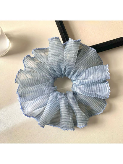 Scrunchies arranged in a circle highlighting their soft fabric and prints