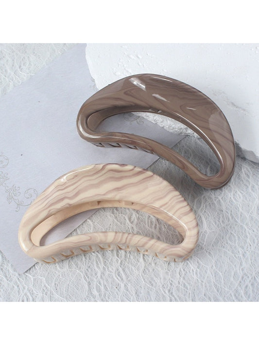 Beau semi circular hollow hair clip in matte gold finish on white background