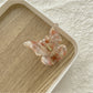 Beau light color butterfly claw clip with soft pastel shades and translucent wings