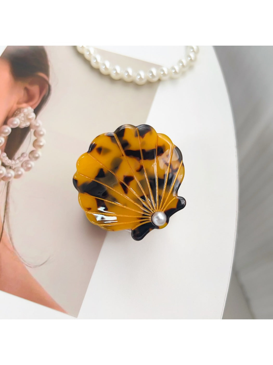 Beau hair claw clip placed on wooden surface showing glossy finish