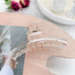Pastel curved claw clip shown from top angle highlighting smooth edges