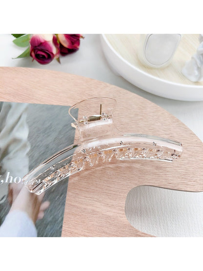 Pastel curved claw clip shown from top angle highlighting smooth edges