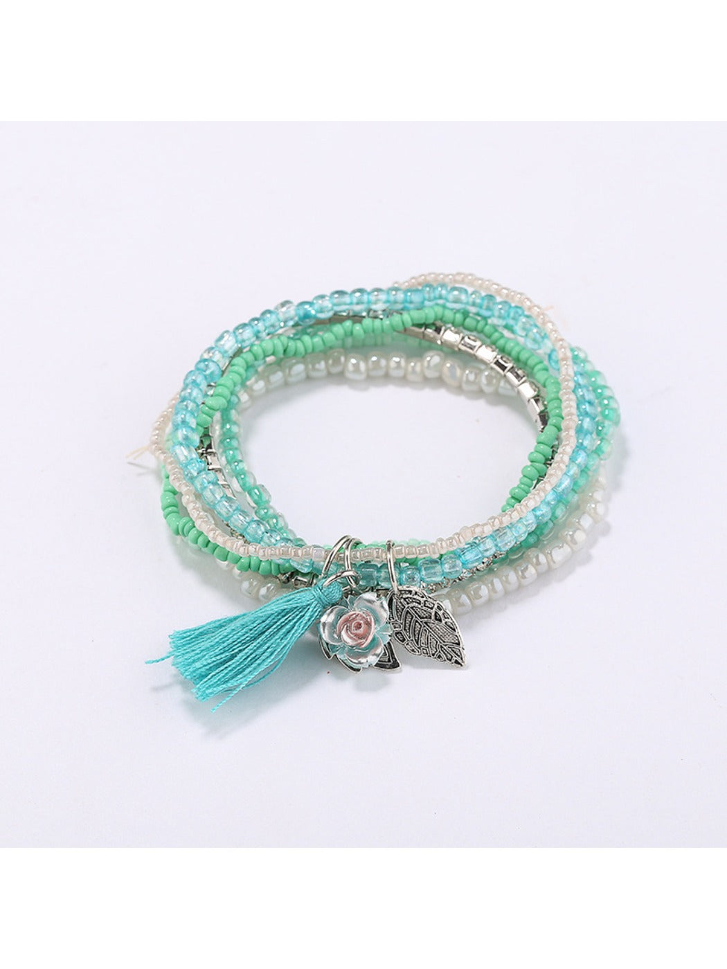 Lovra bracelet worn on wrist highlighting layered beads and pink tassel charm