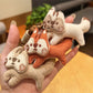 Keypus squirrel charm keychain hanging from a silver keyring on white background