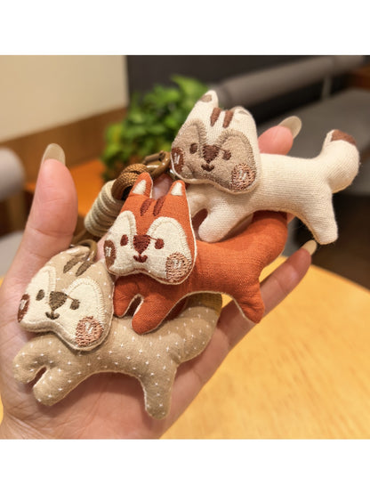 Keypus squirrel charm keychain hanging from a silver keyring on white background