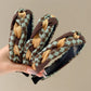 Close-up of Gifty fabric woven twist headband in soft pastel colors