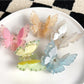 Beau two tier butterfly shaped claw clip in pastel pink on white background