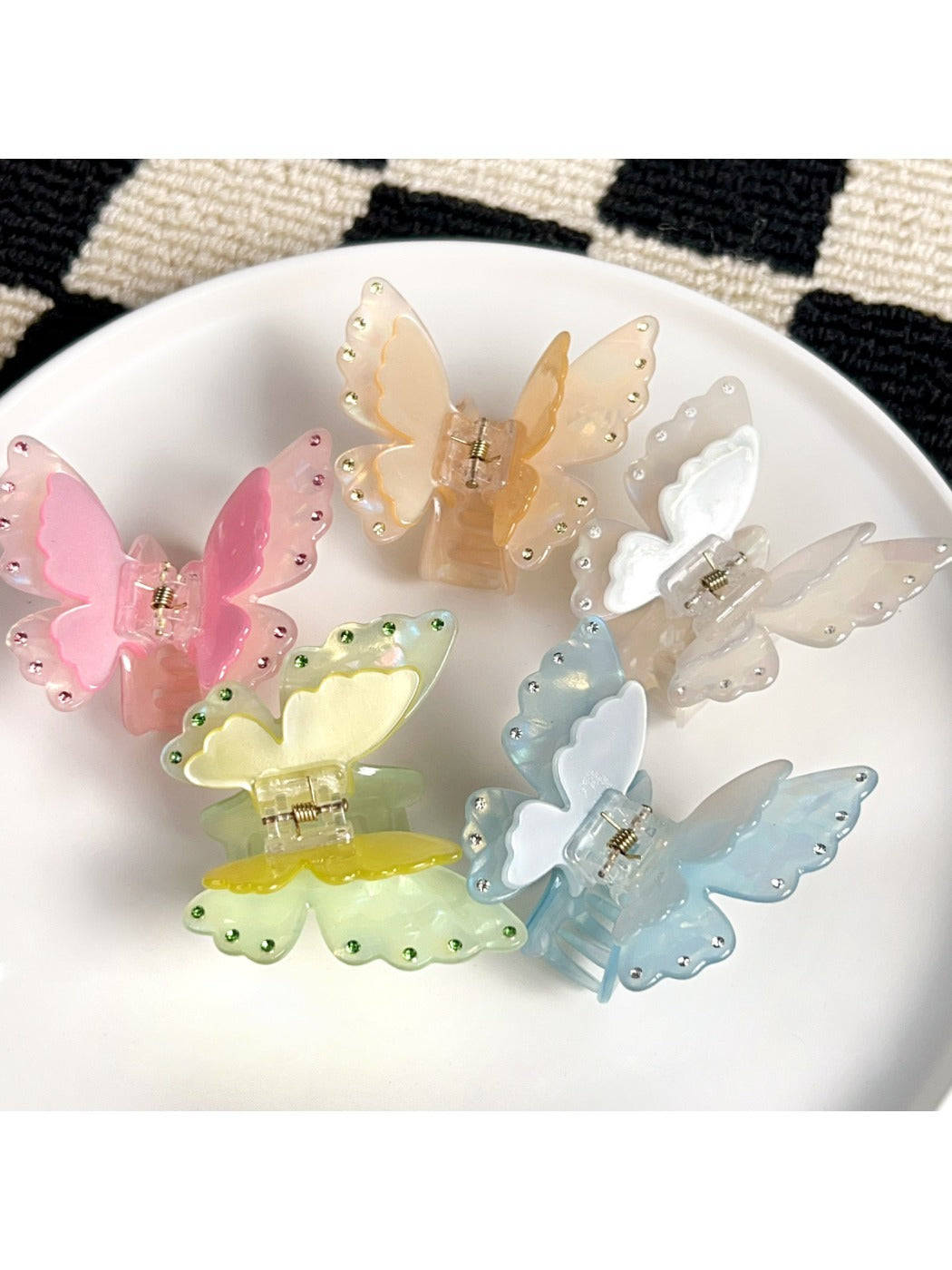 Beau two tier butterfly shaped claw clip in pastel pink on white background
