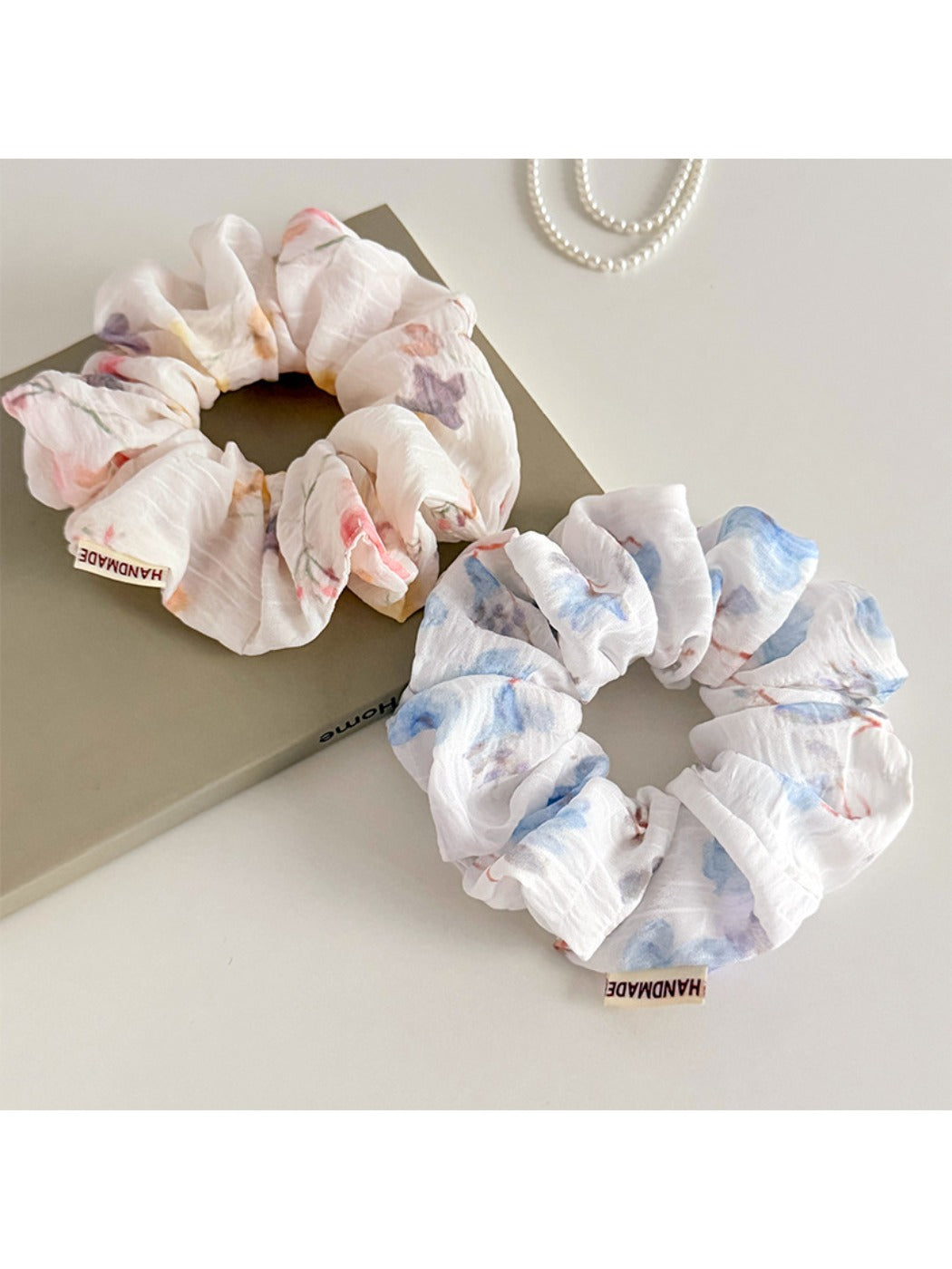 Gifty ombre print scrunchie in pastel pink and purple shades on a white background