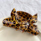 Beau claw clip displayed with butterfly decoration and leopard print pattern