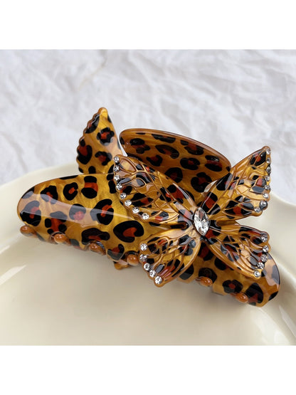 Beau claw clip displayed with butterfly decoration and leopard print pattern