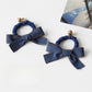 Vintage bow hair tie styled on a model's ponytail showing fabric details