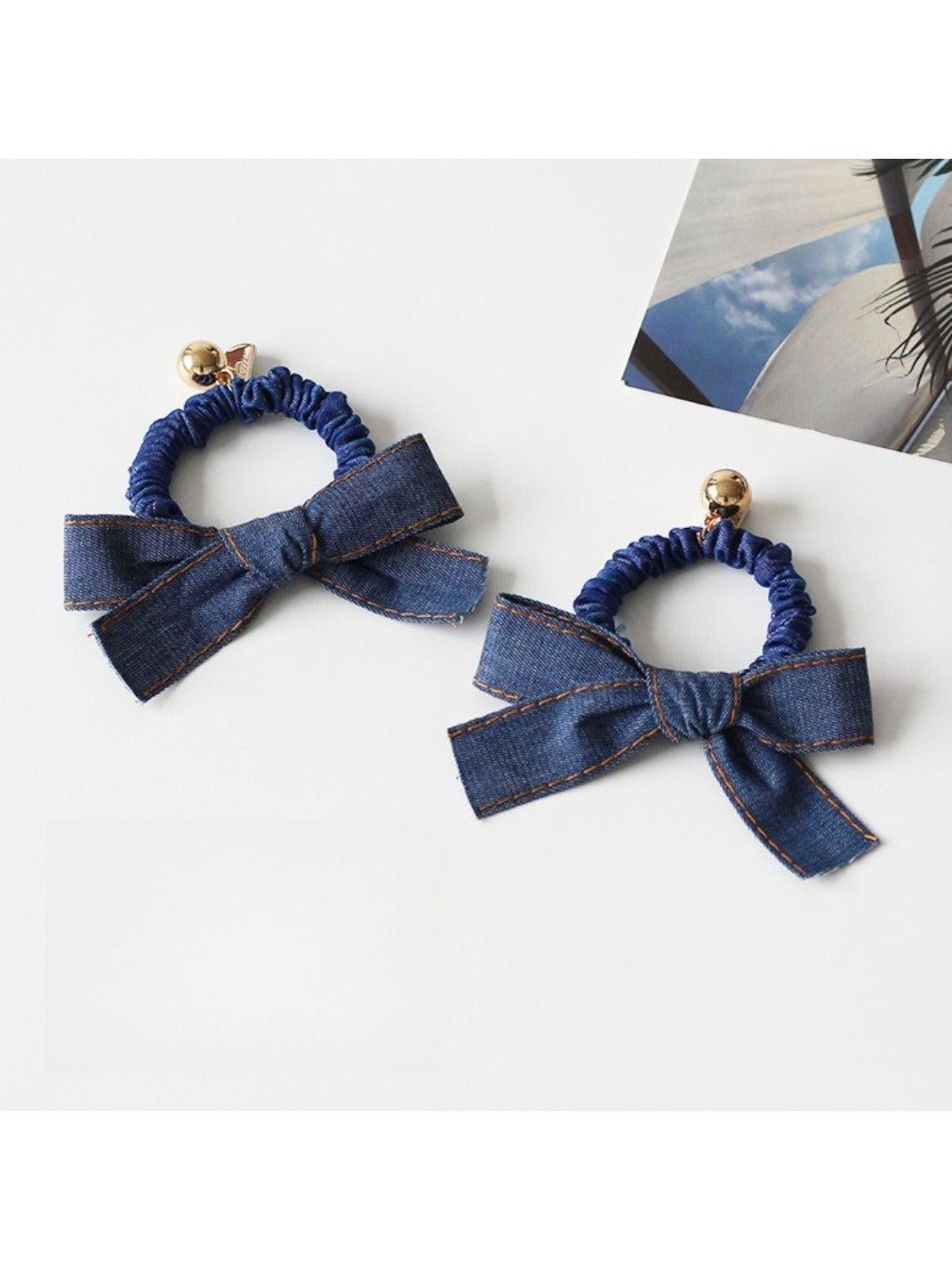 Vintage bow hair tie styled on a model's ponytail showing fabric details