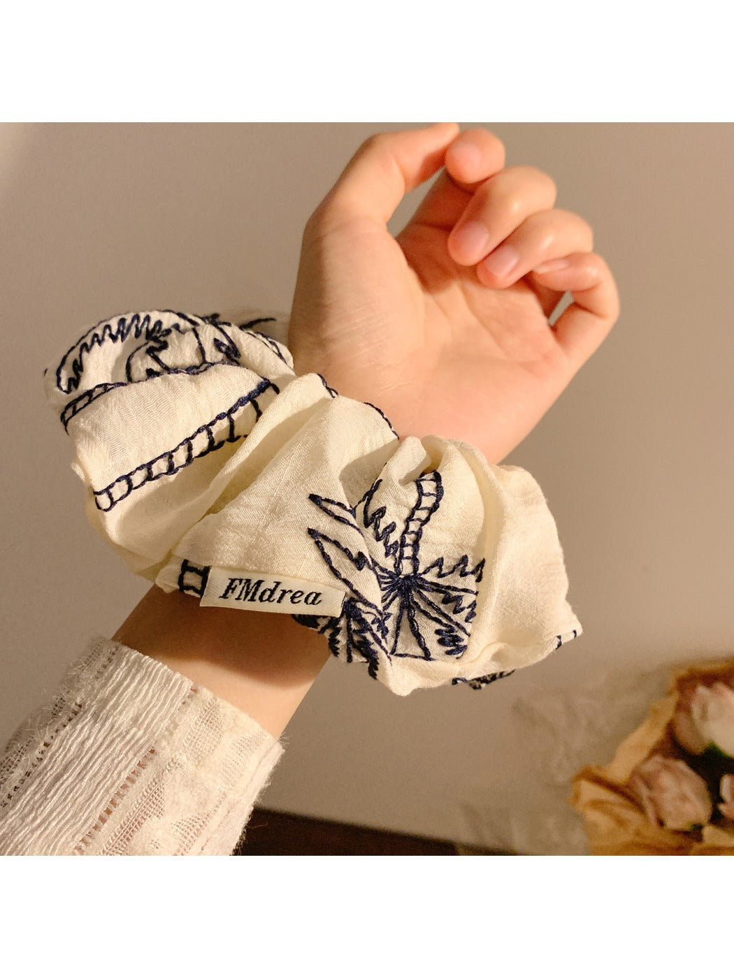 Side view of elastic scrunchie featuring vintage coconut tree pattern