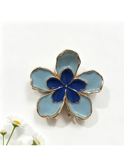 Side view of Beau flower shaped hair clip clipped into hair with visible metal clasp