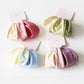 Set of minimalist solid color hair ties in neutral shades on a white background