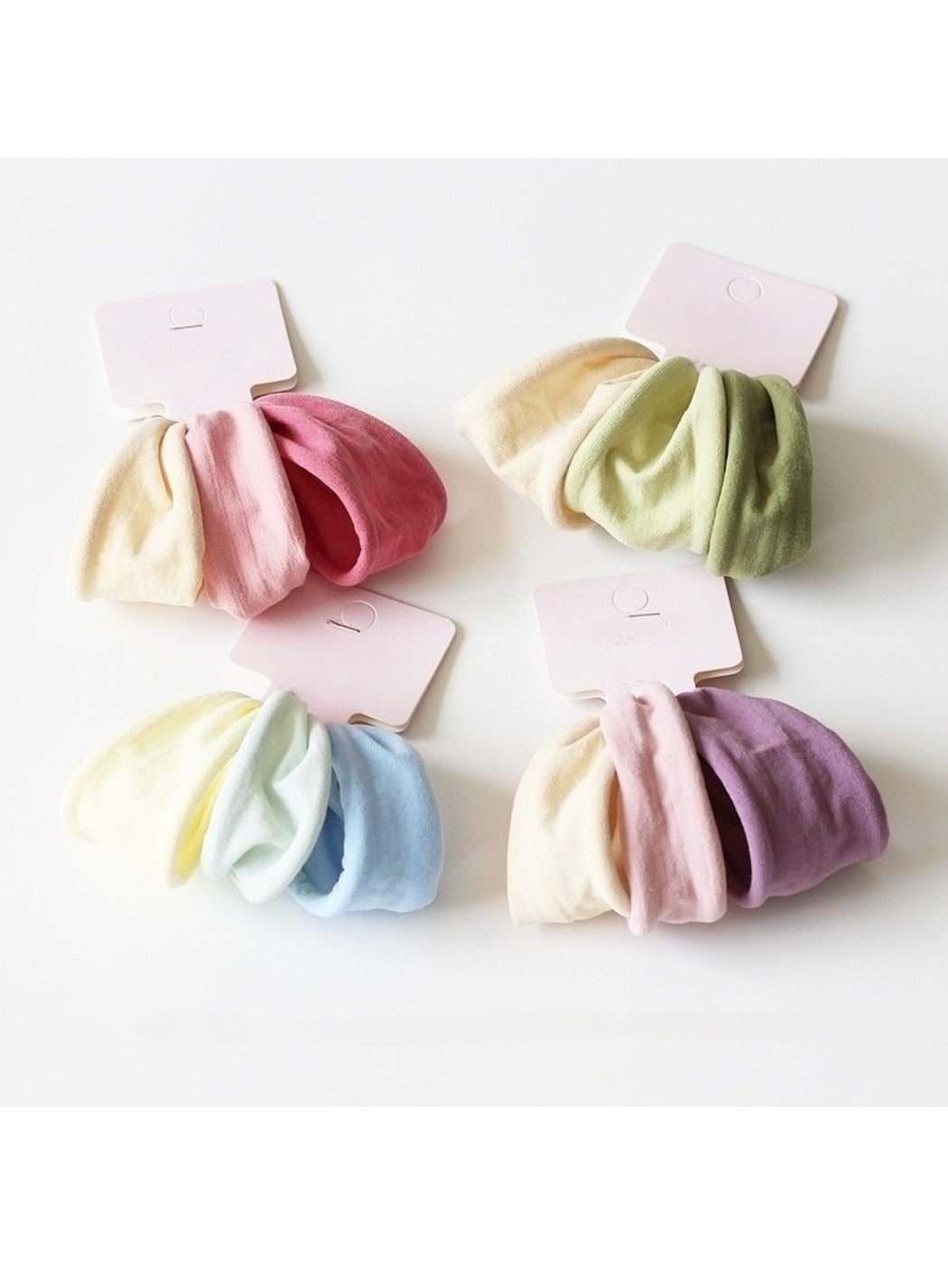 Set of minimalist solid color hair ties in neutral shades on a white background