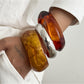 Side view of Lovra vintage polished irregular bangle bracelet highlighting shape