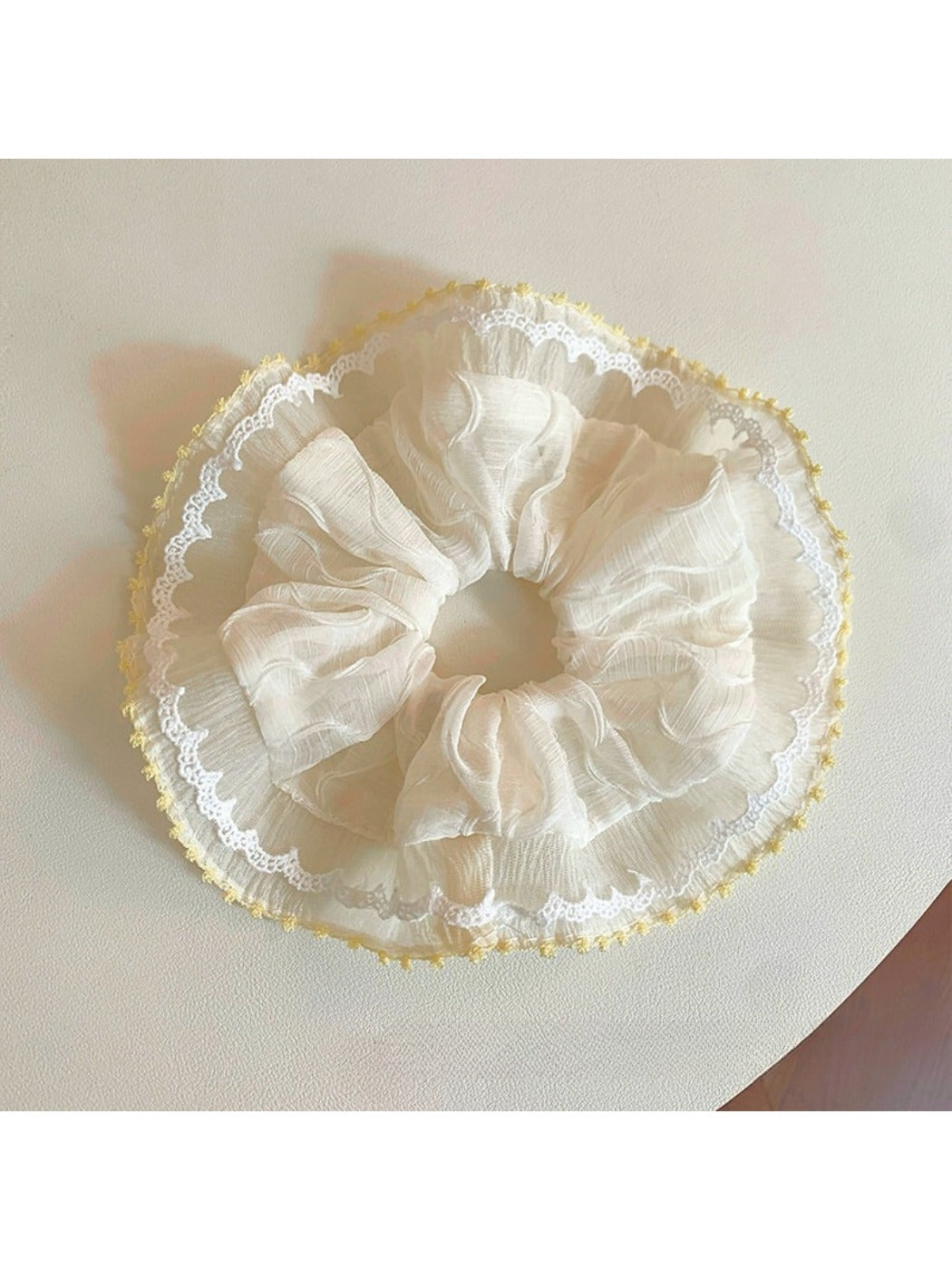 Close-up of Gifty minimalist modern ruched scrunchie in soft beige fabric