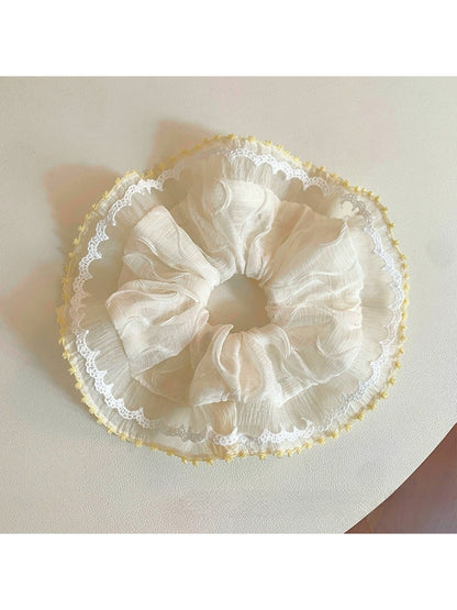 Close-up of Gifty minimalist modern ruched scrunchie in soft beige fabric