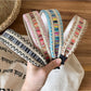Gifty vintage wide edge woven headband in beige and brown tones displayed on a white background