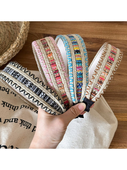Gifty vintage wide edge woven headband in beige and brown tones displayed on a white background