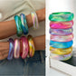 Lovra bangle bracelet worn on wrist with colorful abstract design