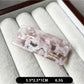 Beau curved bar hair clip with clasp mechanism visible