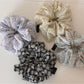 Side view of Gifty scrunchie highlighting gathered fabric and floral pattern