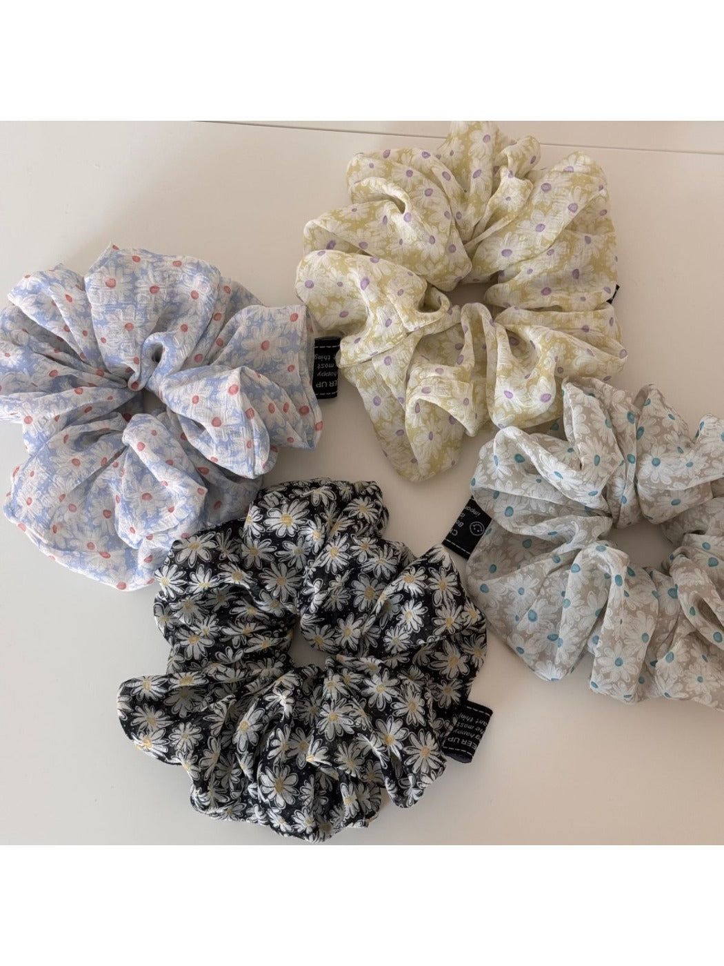 Side view of Gifty scrunchie highlighting gathered fabric and floral pattern