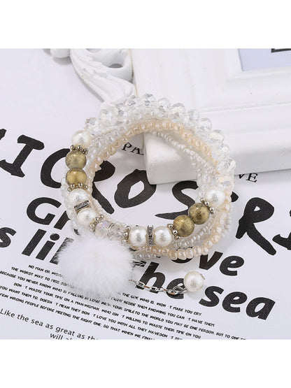 Lovra bracelet worn on wrist highlighting vibrant beads and soft pompom charm