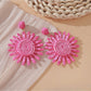 Pink and black raffia woven earrings styled with casual outfit