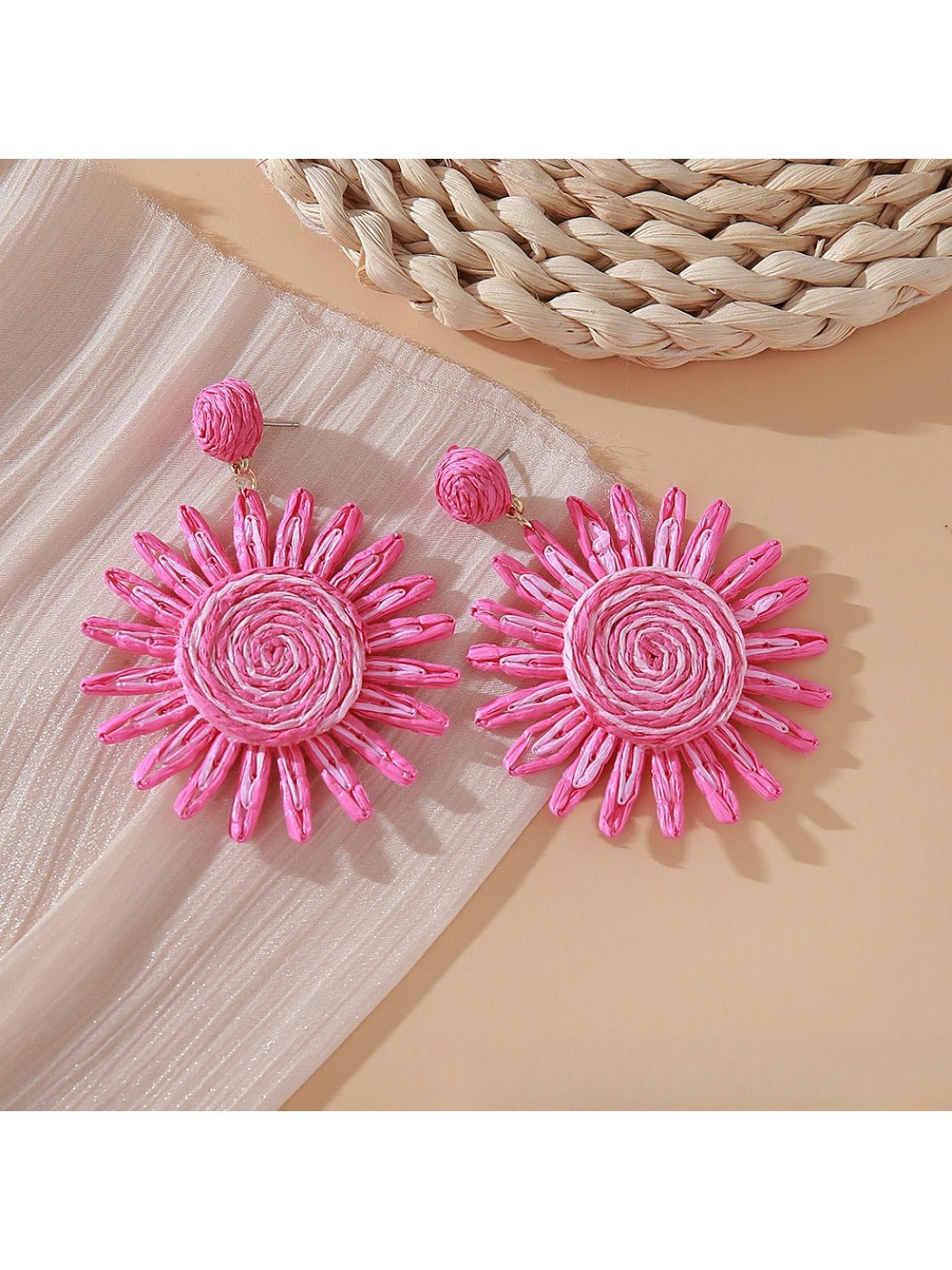 Pink and black raffia woven earrings styled with casual outfit