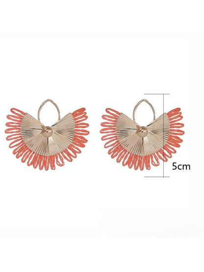 Side view of Earedge raffia woven fan shape earrings showing texture and weave