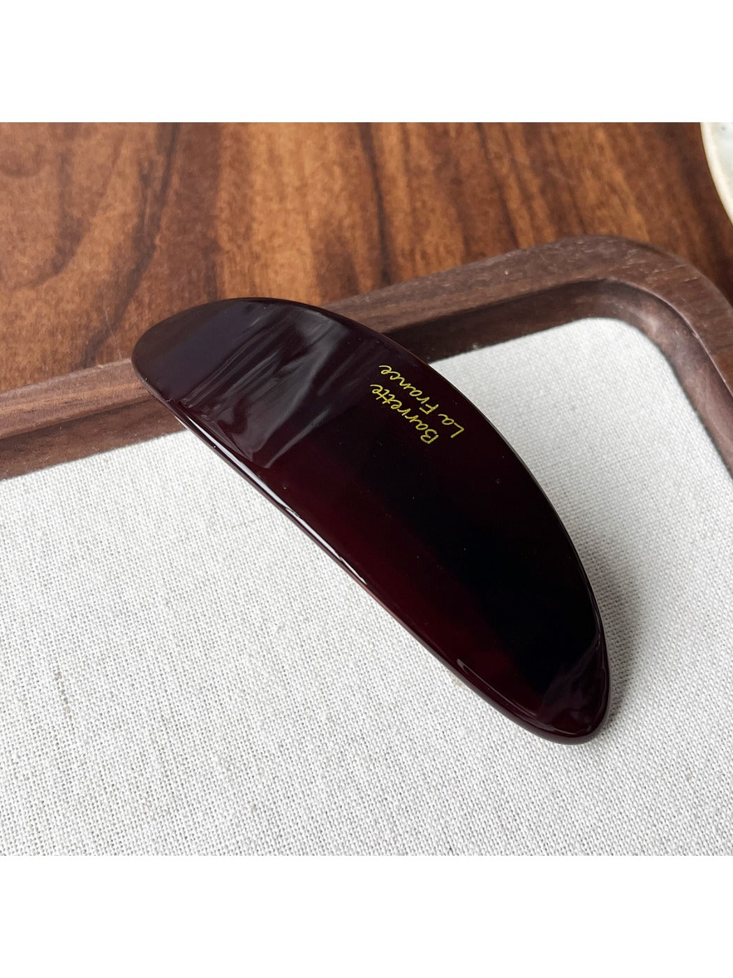 Beau acetate ponytail clip with tortoiseshell pattern isolated on a plain white background