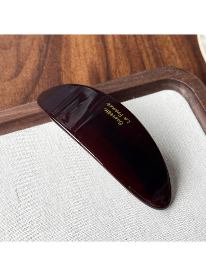 Beau acetate ponytail clip with tortoiseshell pattern isolated on a plain white background