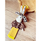 Keypus keychain hanging from a bag zipper with vibrant patchwork colors