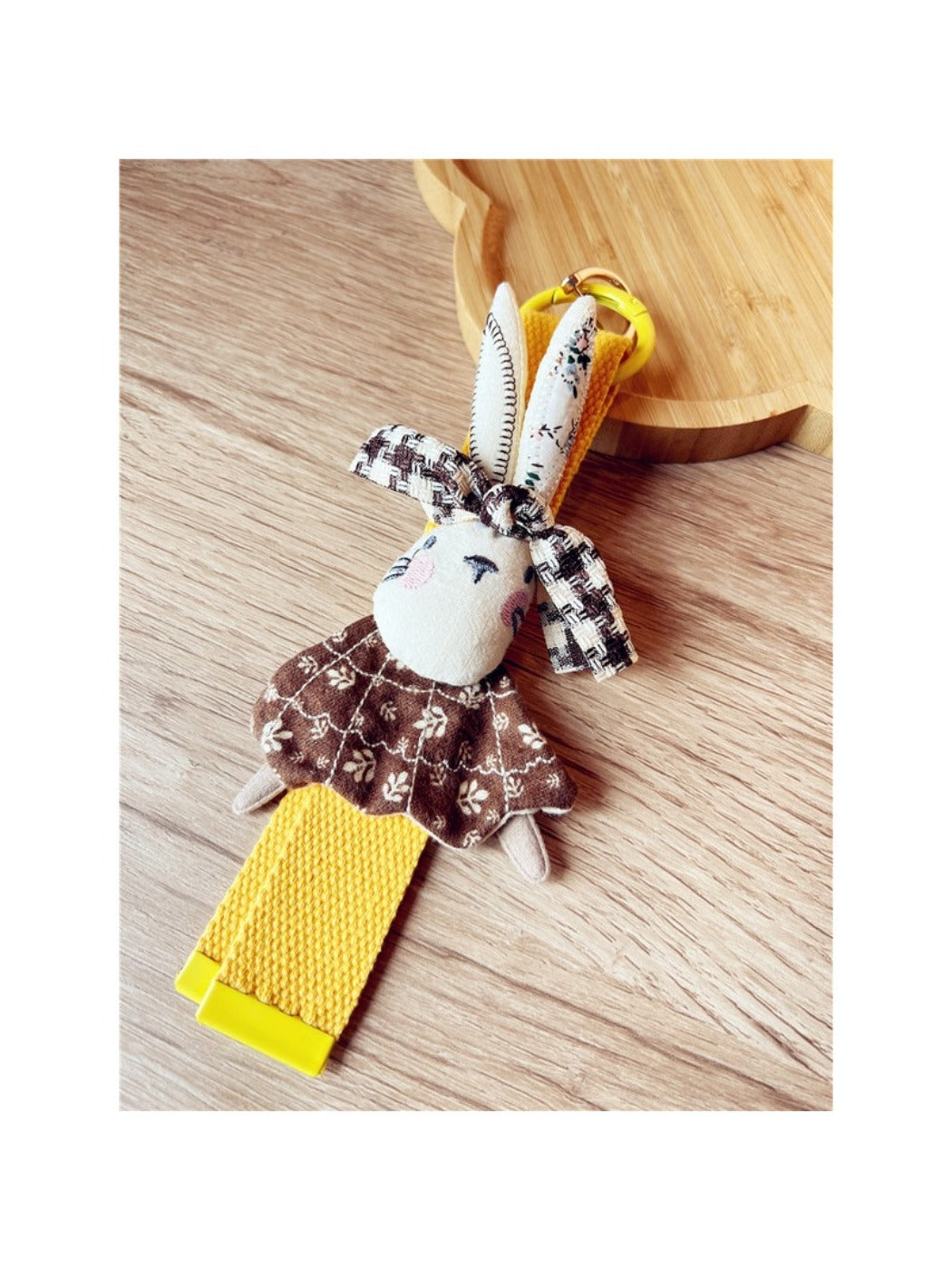 Keypus keychain hanging from a bag zipper with vibrant patchwork colors