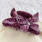 Beau leopard print claw clip with butterfly detail against neutral background