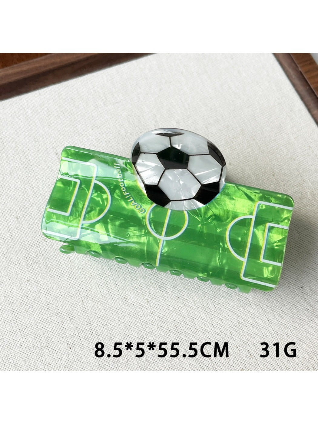 Beau claw clip with soccer ball design displayed on a white background