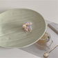 Beau sweet flower shaped small claw clip displayed with soft natural lighting