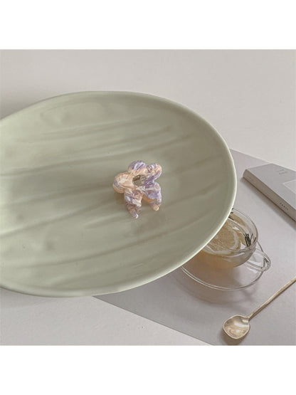 Beau sweet flower shaped small claw clip displayed with soft natural lighting